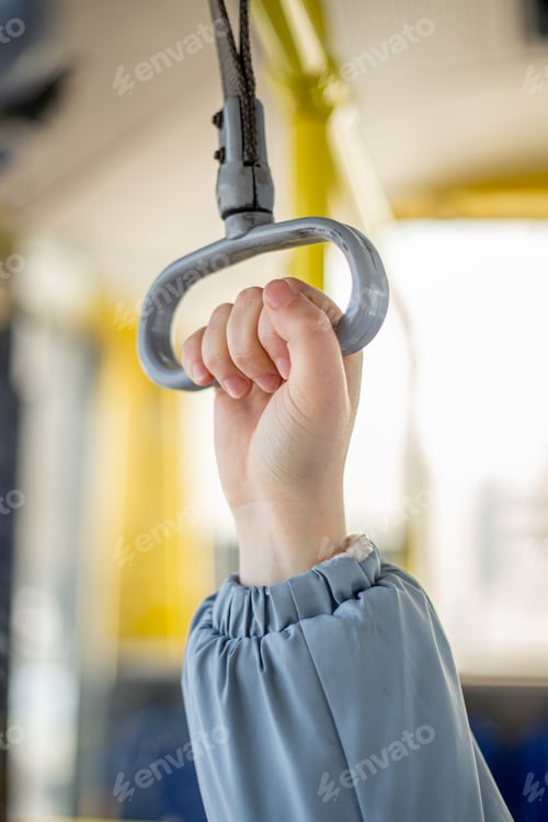 Preview: Public transport. Hand holding on to the handrail. Travel by bus.