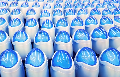 Preview: Deodorant, bottles with blue lids in a row.