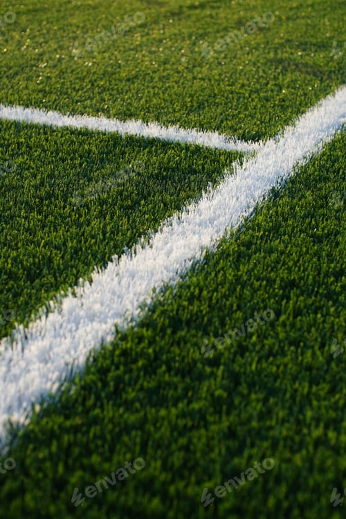 Preview: green synthetic grass surface on a soccer ground, european football field with artificial grass