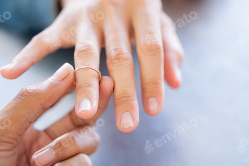 Preview: Close-Up of a Hand Holding a Gold Ring