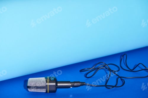 Preview: black microphone on bright and colorful background with copy space