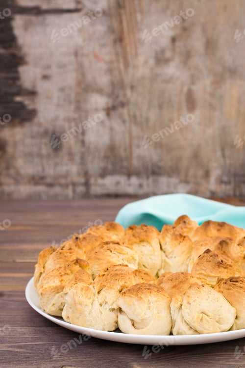 Preview: Homemade monkey bread close-up on a plate and napkin on a wooden table