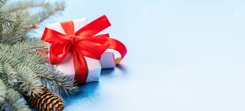 Preview: Christmas fir tree branch and gift box over blue