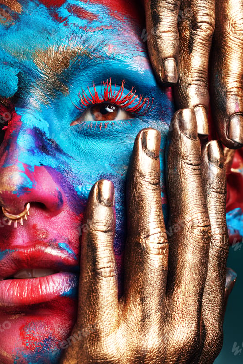 Preview: Cropped shot of an attractive young woman posing alone in the studio with paint on her face