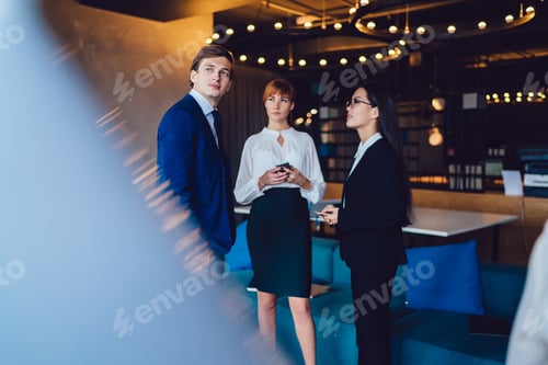 Preview: Colleagues having informal meeting and talking in office lounge