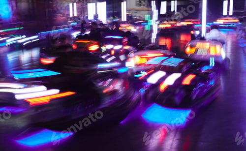 Preview: Blurred motion of bumper cars and neon lights