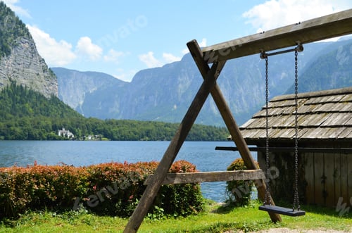 Preview: Wooden swing and small house on picturesque riverbank