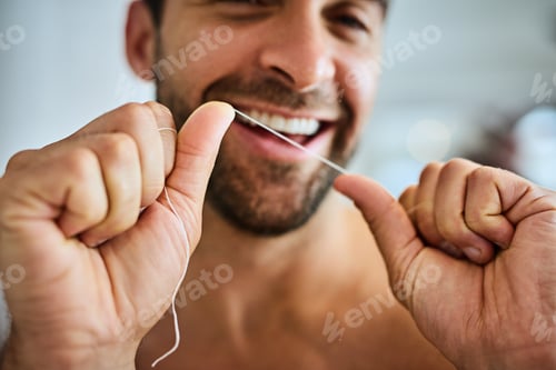Preview: Getting my teeth completely clean. Shot of a handsome young man flossing at home.