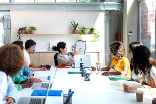 Preview: Group of multiracial employees listen to female boss share year business results. Copy space.