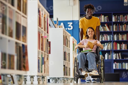 Preview: Young Man Assisting Student with Disability in Library