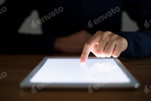 Preview: Woman use of tablet pc at night