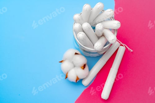 Preview: Female medical tampons on pink and blue background