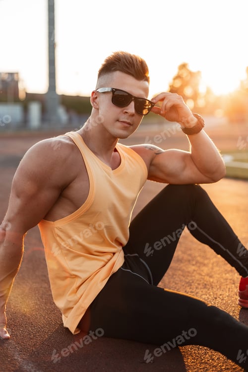Preview: Handsome healthy athletic muscular man at sunset