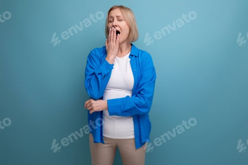 Preview: sleepy blond mature woman with on studio background