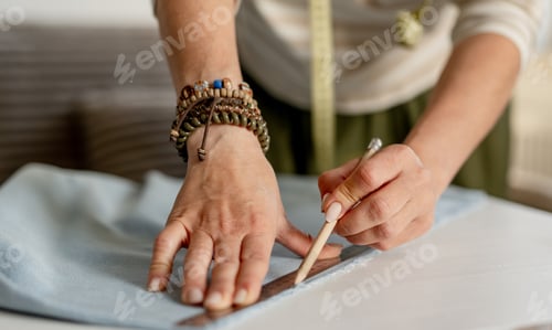 Preview: Woman Drawing Line On Fabric With Ruler