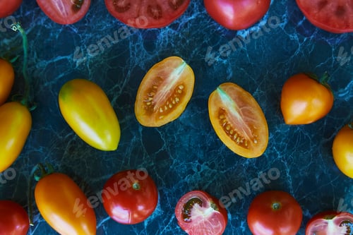 Preview: Autumn vegetables. Colorful red, orange and yellow tomatoes on green marble background.