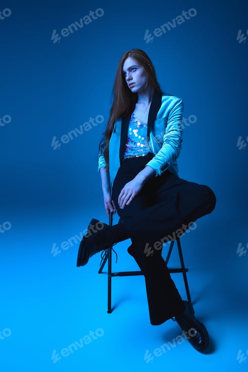 Preview: Expressing identity with vibrant colors and confident poses in a blue toned setting
