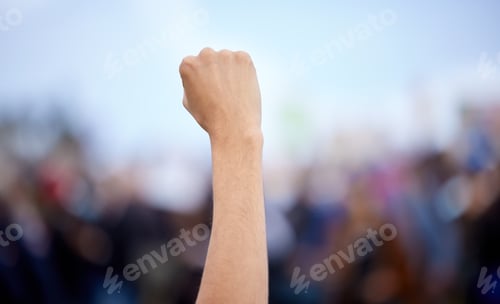 Preview: We will be heard. Unrecognisable demonstrators holding up their fists in protest.