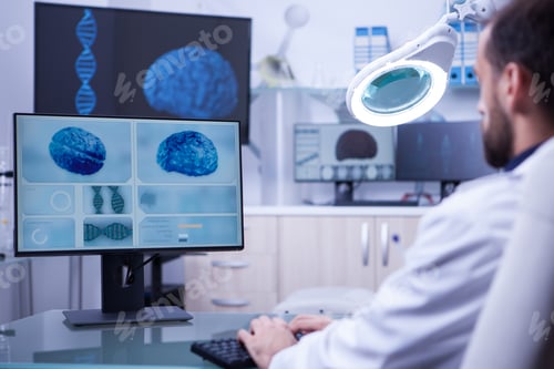 Preview: Young medical assistant working on computer in a hospital laboratory