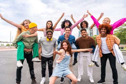 Preview: Happy playful multiethnic group of young friends bonding outdoors