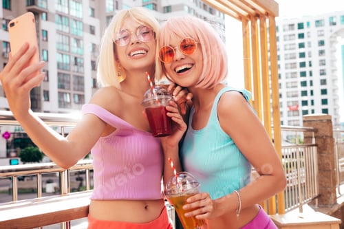 Preview: Two young beautiful women posing outdoors