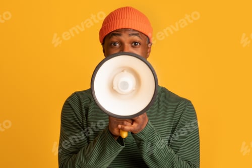 Preview: Portrait Of Young Black Hipster Guy With Loudspeaker In Hands Making Announcement