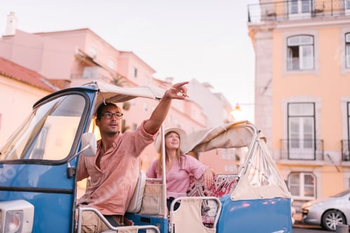 Preview: Tuk tuk driver providing tour of the city to a tourist, Lisbon, Portugal