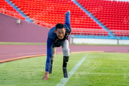 Preview: Asian para-athletes with prosthetic blades sprint on a running track at stadium.