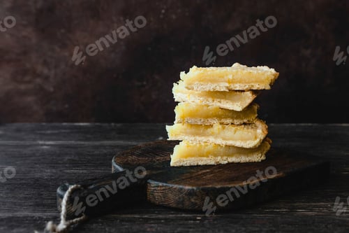 Preview: pieces of delicious lemon pie on each other on cutting board