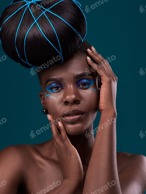 Preview: Studio portrait of a beautiful young woman posing against a dark background