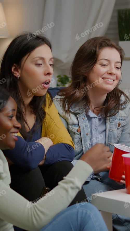 Preview: Multiethnic friends sitting on couch having online videocall meeting