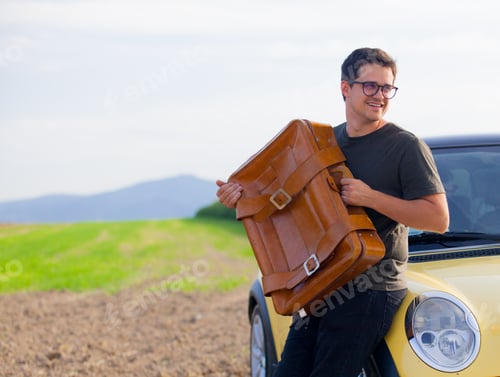 Preview: Young man with travel suitcase