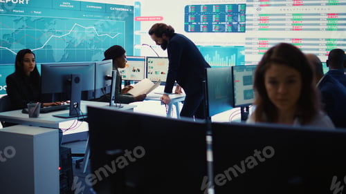 Preview: Marketing specialist studying infographics on computer in a monitoring room