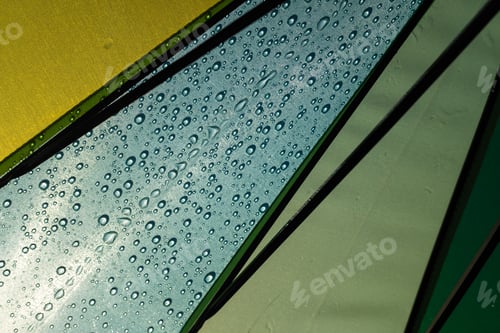 Preview: Detail of an umbrella with raindrops after a rainy day.