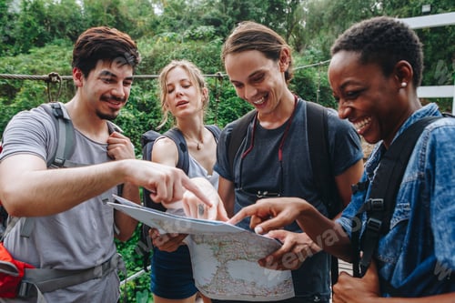 Preview: Group of friends looking at a map together travel and teamwork concept