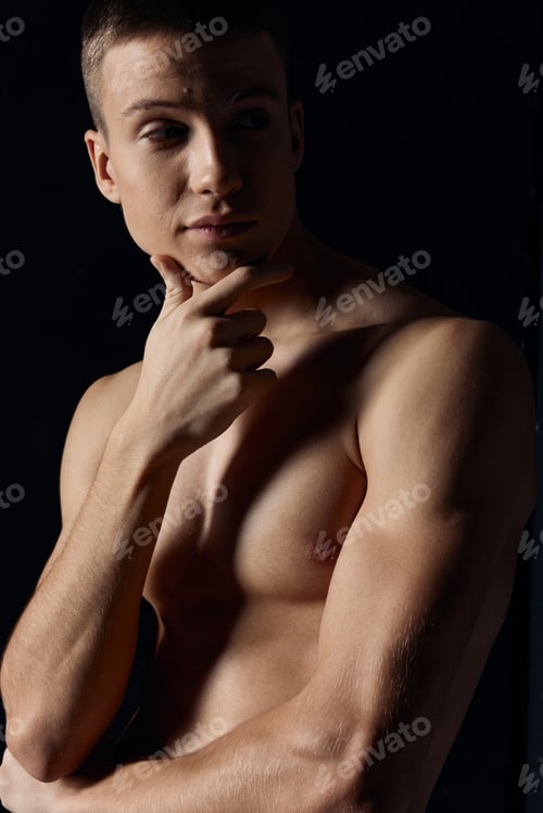 Preview: portrait of an athlete on a dark background training muscles model cropped view