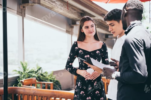 Preview: Multiracial friends sitting in cafe enjoying coffee during work break