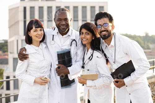 Preview: Portrait of team of multinational doctors in white coats with stethoscopes