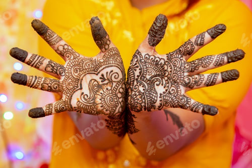 Preview: Closeup shot of female hands painted with mehndi