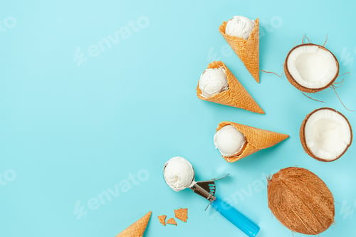 Preview: Waffle ice cream cones with coconut on blue background. Top view, copy space.