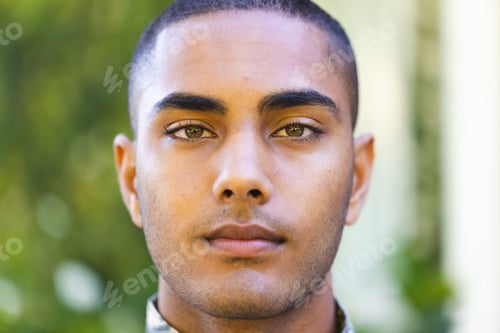 Preview: Portrait of biracial male soldier wearing military uniform looking at camera