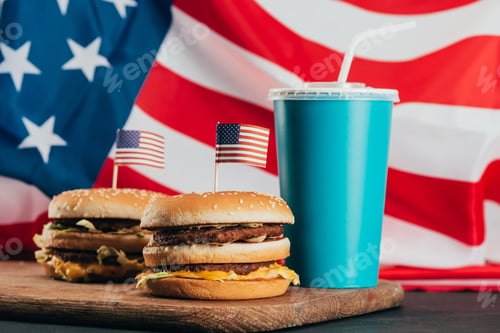 Preview: close up view of burgers with american flags and soda drink, presidents day celebration concept