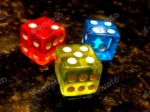 Preview: Colorful translucent red yellow and blue dice for game plane or game night chance gambling