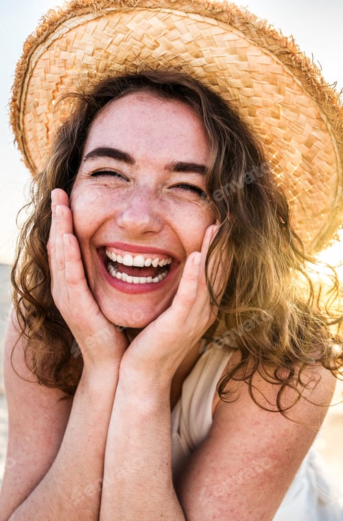 Preview: Happy beautiful young woman smiling at the beach side