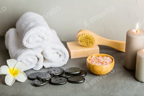 Preview: Mockup for spa massage salon with hot spa stones, candles and natural cosmetics on gray background