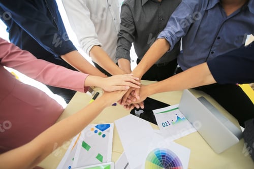 Preview: Stack of hands showing unity and teamwork