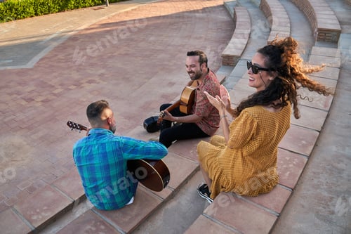 Preview: Flamenco guitarists and singer performing outdoors, woman clapping to the rhythm