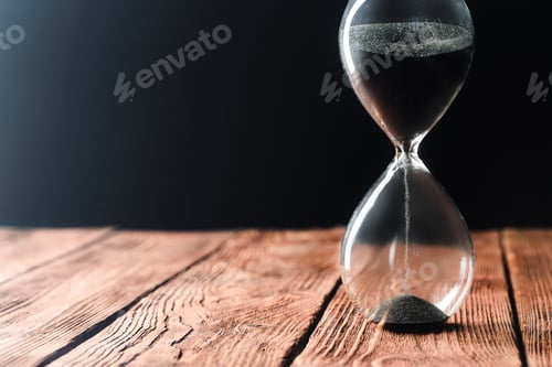 Preview: Modern hourglass on wooden background. Close up