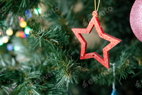 Preview: wooden Christmas tree toy in the shape of a star hanging on a branch, close-up