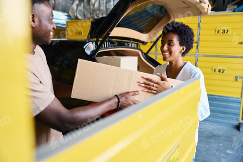 Preview: African American guys unload boxes of things from the car
